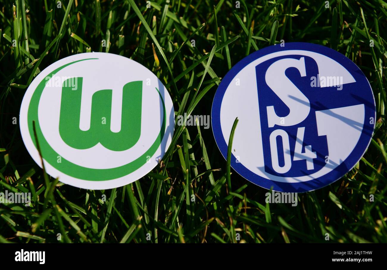 September 6, 2019, Munich, Germany. Emblems of German football clubs Schalke 04 Gelsenkirchen and VfL Wolfsburg on the green lawn Stock Photo