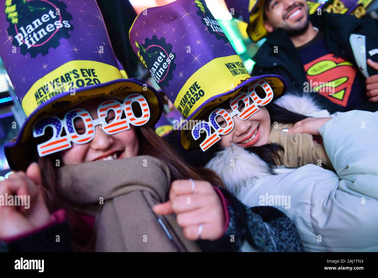 New Years Eve revelers are seen during the Times Square New Year's Eve 2020 Celebration on December 31, 2019 in New York City. Stock Photo