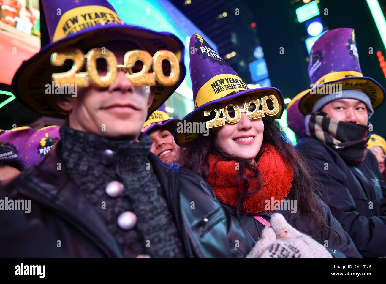 New Years Eve revelers are seen during the Times Square New Year's Eve 2020 Celebration on December 31, 2019 in New York City. Stock Photo