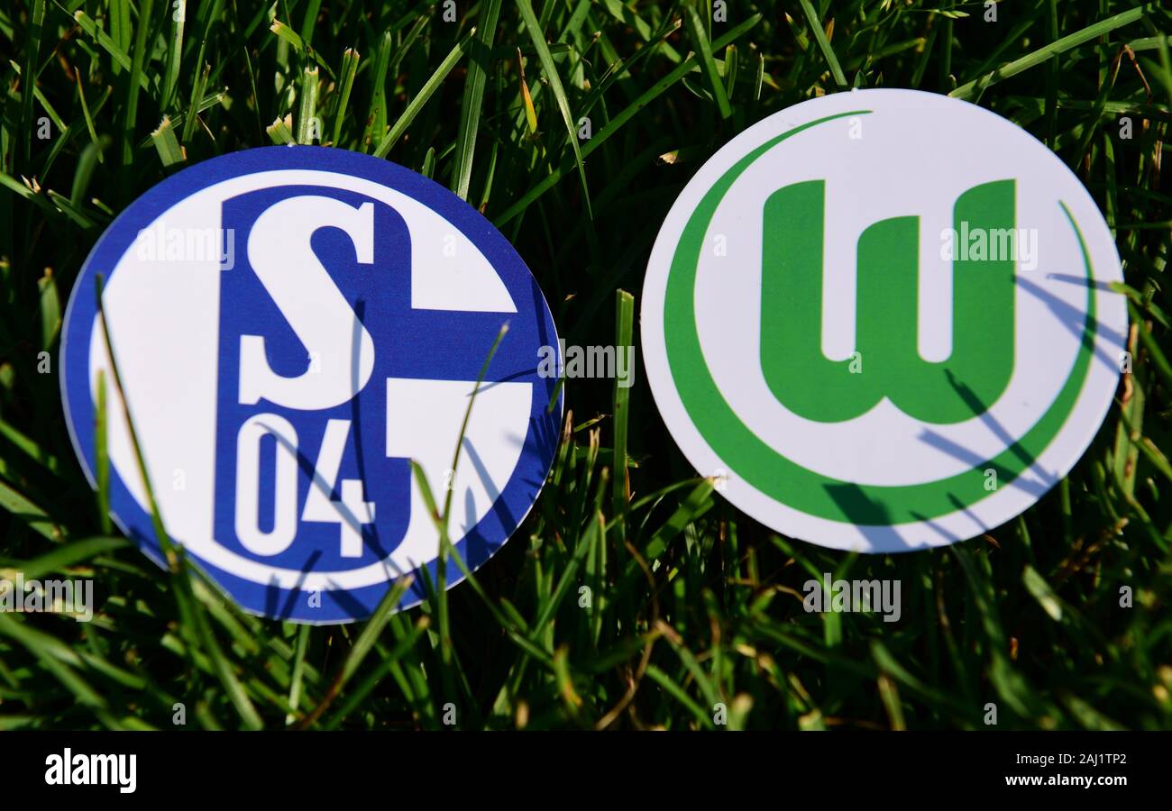 September 6, 2019, Munich, Germany. Emblems of German football clubs Schalke 04 Gelsenkirchen and VfL Wolfsburg on the green lawn Stock Photo