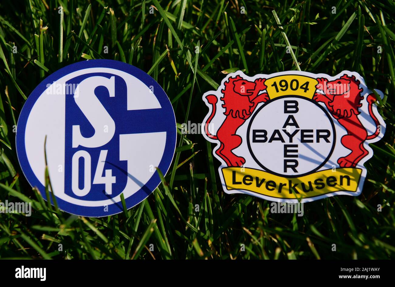 September 6, 2019, Munich, Germany. Emblems of German football clubs Bayer Leverkusen and Schalke 04 Gelsenkirchen on the green lawn Stock Photo