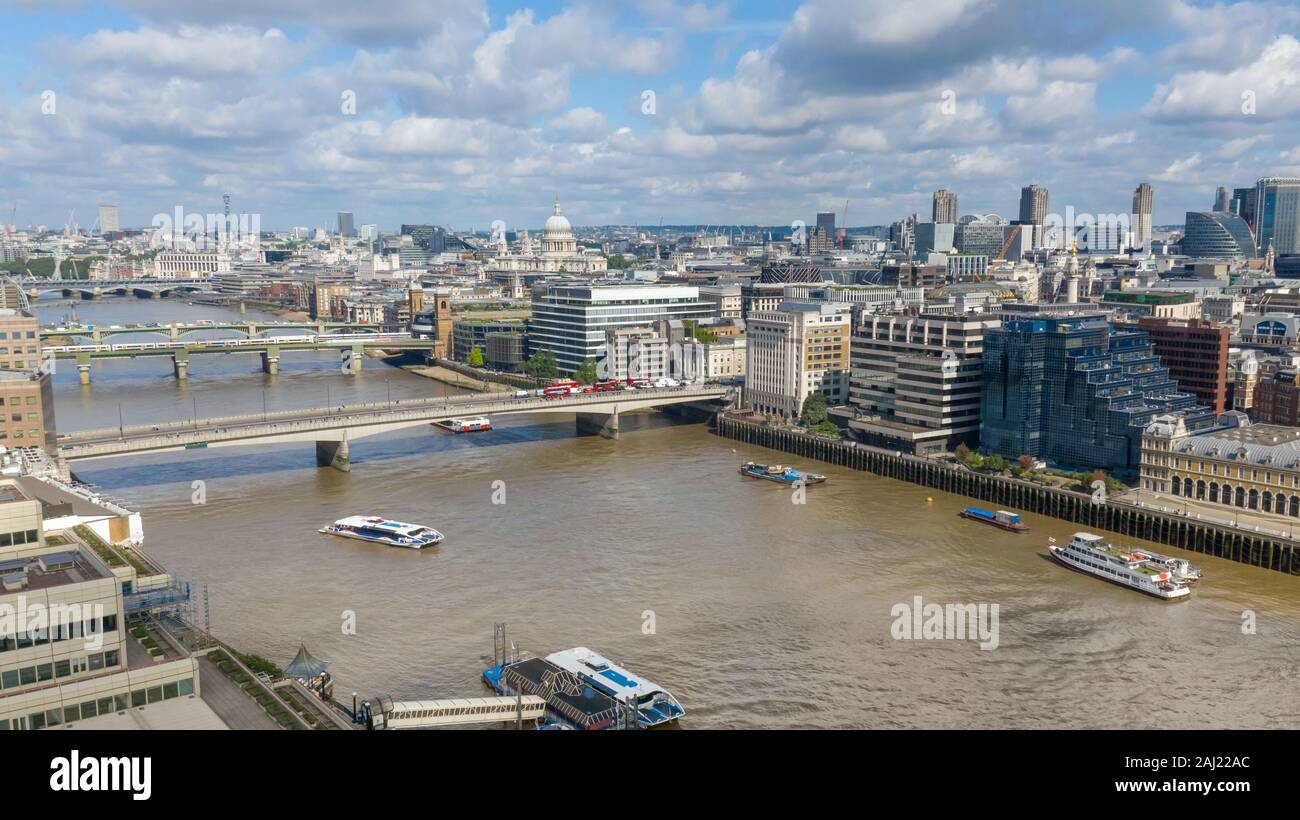 River Thames Aerial view of London Skyline filled with bridges, ships, and modern architecture buildings located at the heart of the city center Stock Photo