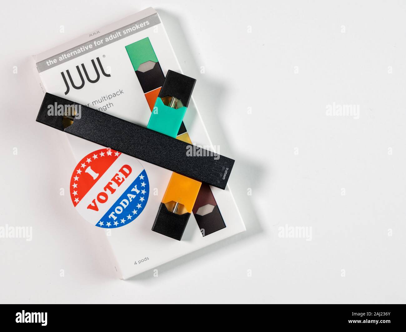Morgantown, WV - 2 January 2020: Juul flavored nicotine vaping system with I Voted sticker to illustrate political issues with a ban Stock Photo