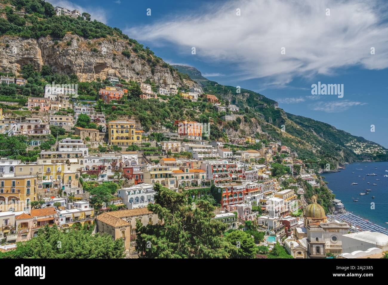 Sunny view of Positano low-rise buildings with church and cliffs, Positano, Costiera Amalfitana (Amalfi Coast), UNESCO, Campania, Italy Stock Photo