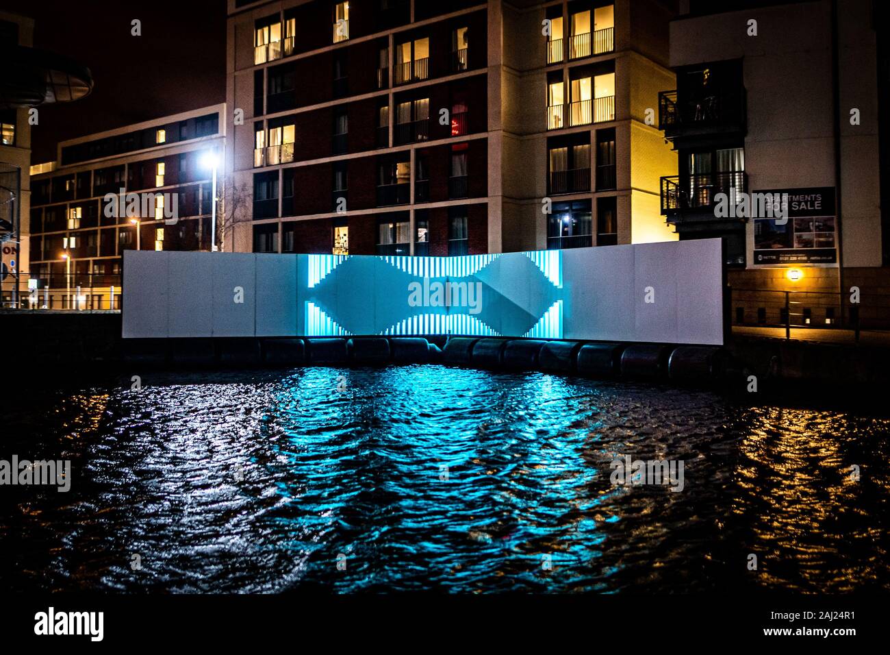 Edinburgh, UK. Wed 1st January 2020. The opening night of “Message from the Skies: Shorelines”, a collection of letters to Scotland reflecting on our relationship with our seas, waters and coasts and our maritime heritage. This projection is “Seascape with WEC” which takes place by the Union Canal in Fountainbridge and features writer Kathleen Jamie, designer Thomas Moulson and projection by Bright Side Studios. Kathleen Jamie’s poem “Seascape with WEC” captures her curiosity with new wave energy converters she witnessed being tested on the Orkney Islands. Stock Photo