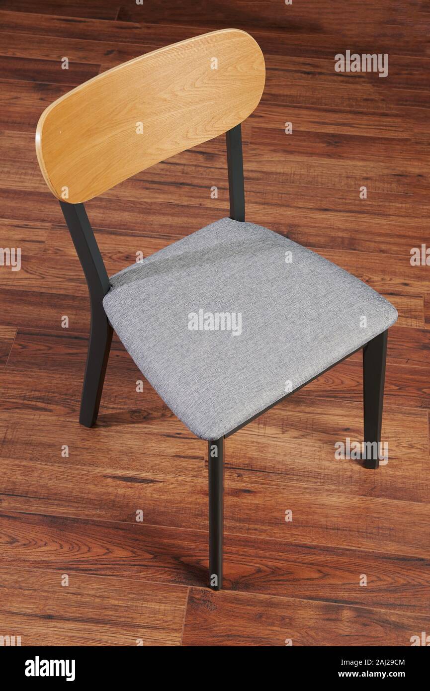 Modern soft chair with wooden back and black legs Stock Photo