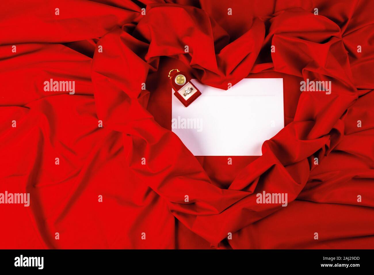 valentine card composition on a red fabric. there is always some madness in love let me be yours message. Stock Photo