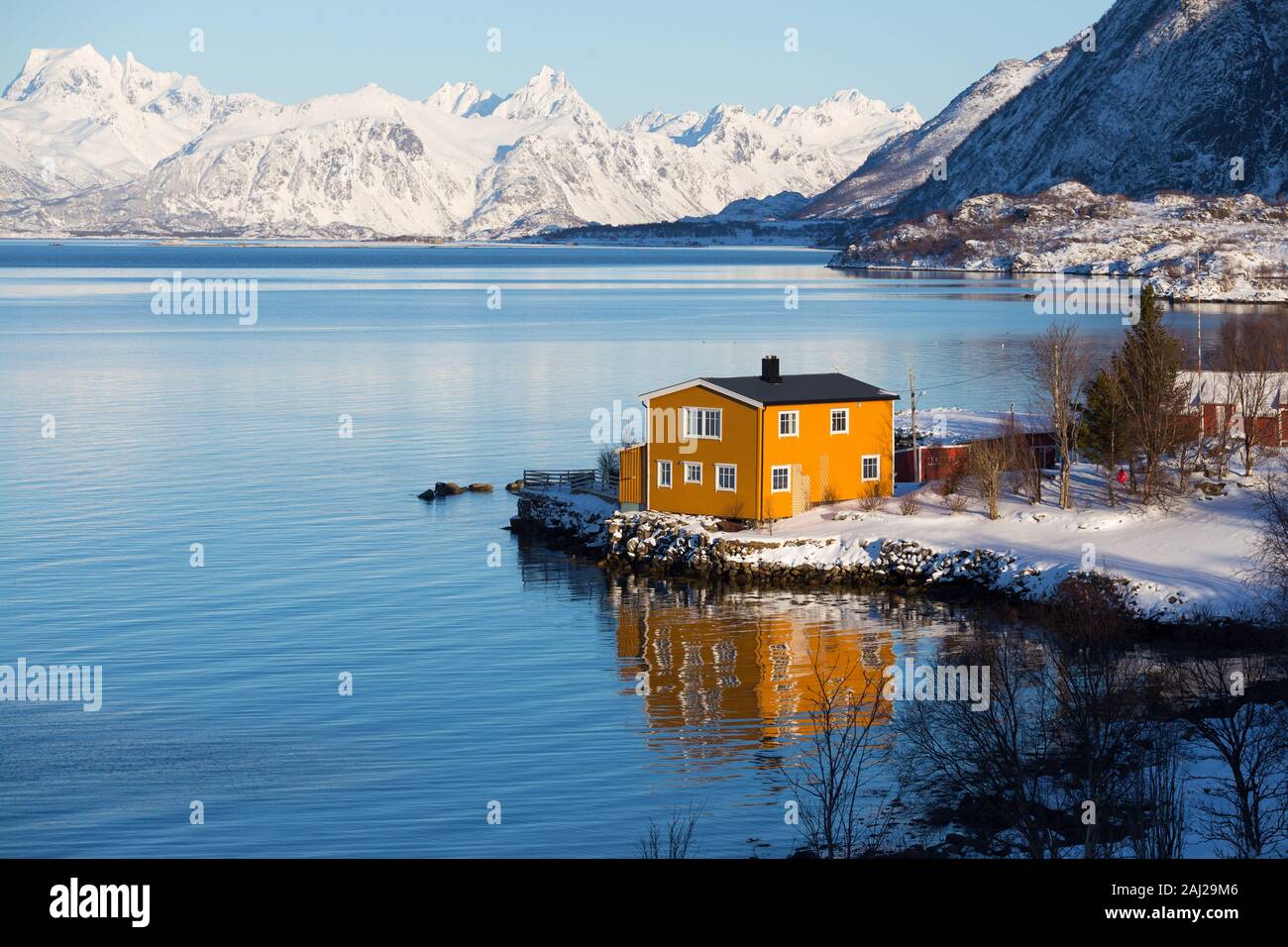 traditional norwegian yellow wooden house to stand at the lakeside and