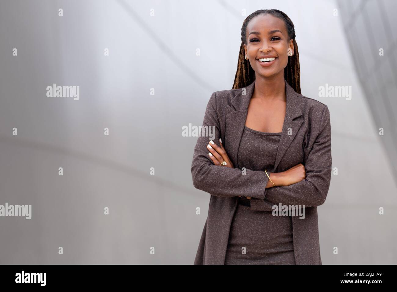 Beautiful african american business woman portrait, arms folded, confident happy financial CEO Stock Photo