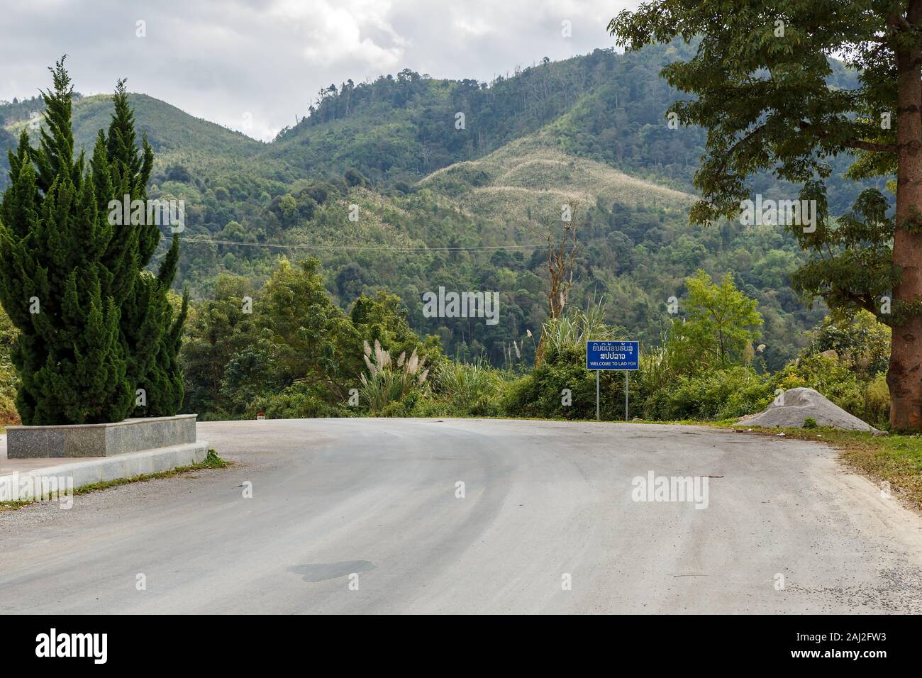 Welcome to Laos, road sign on the border with Vietnam Stock Photo - Alamy