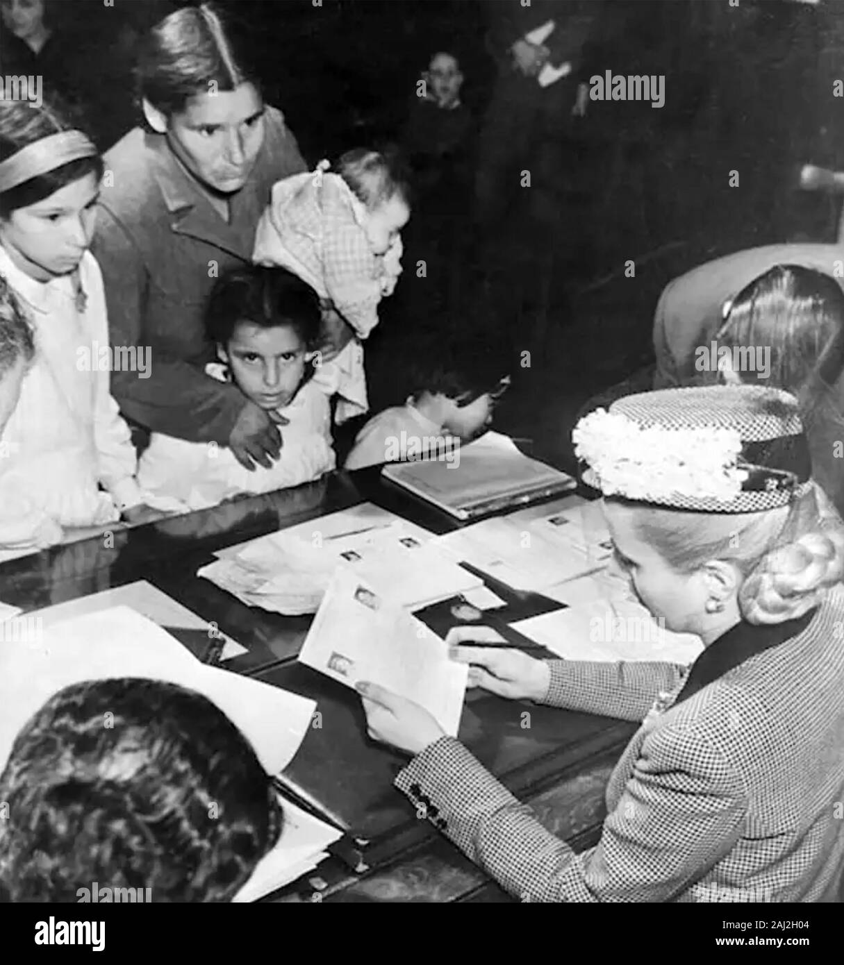 EVITA PERON (1919-1952) as First Lady of Argentina processing applications for help from her Foundation about 1948 Stock Photo