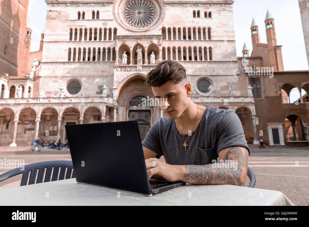 young of the millennials generation using the laptop at the bar of a city of art. technological concept with always connected millennials Stock Photo
