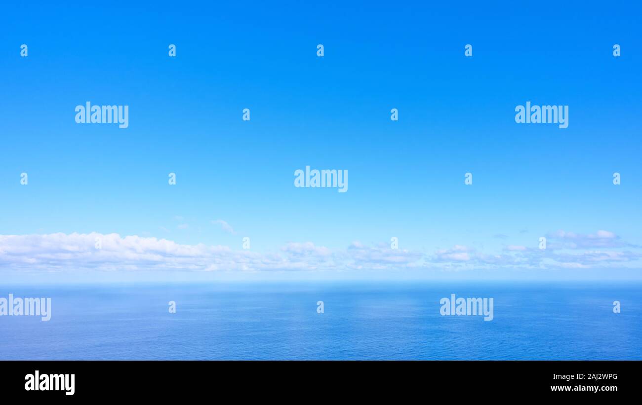 Panorama of the sea with clouds above the horizon in the sky - blue natural background Stock Photo