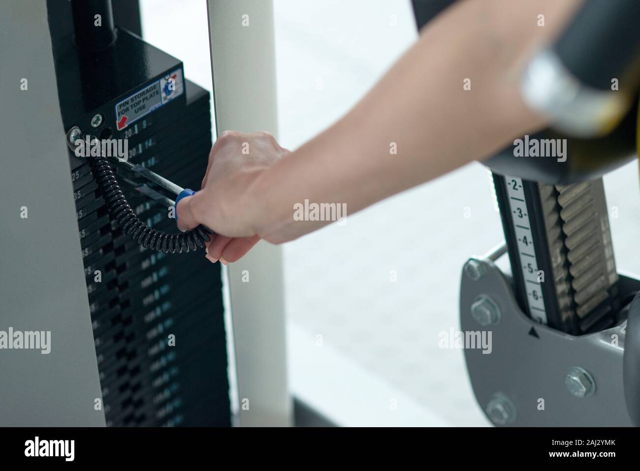 Weight adjustment on training equipment at a gym. Separating weight for