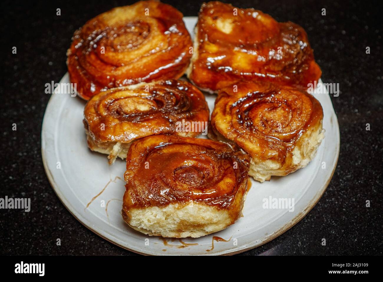 Five homemade sticky buns on a plate Stock Photo
