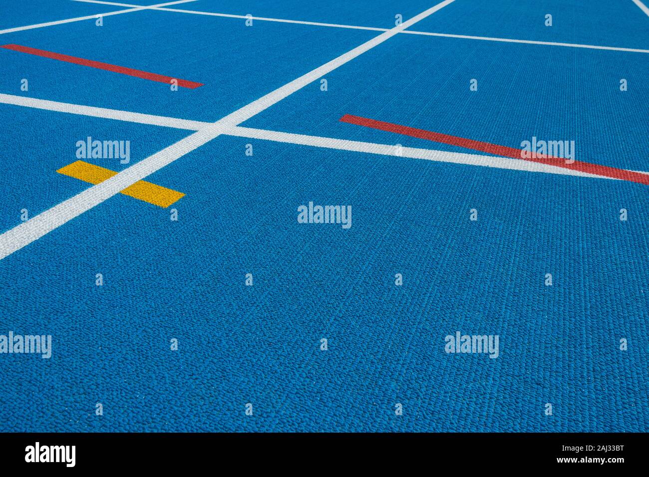 Sport background. Blue running track with white lines, yellow and red ...