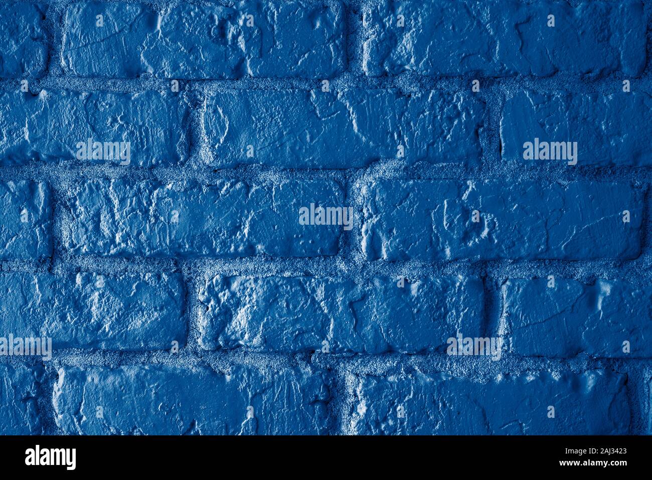 Brick wall vintage toned background in trendy classic dark blue 2020 Stock Photo