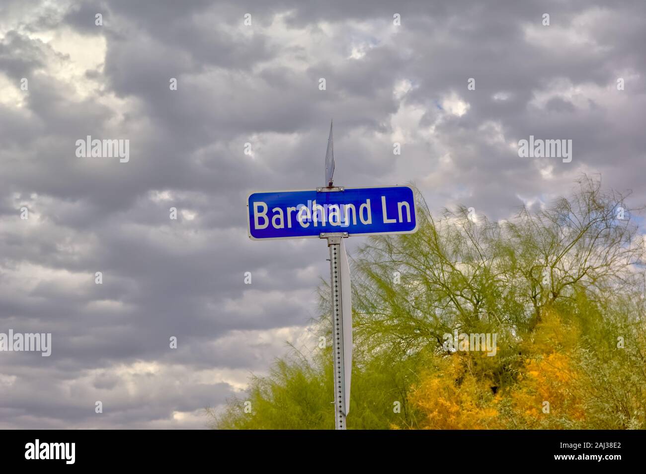 A cloudy day for a strangely named road in Arizona called Barehand Lane. Stock Photo
