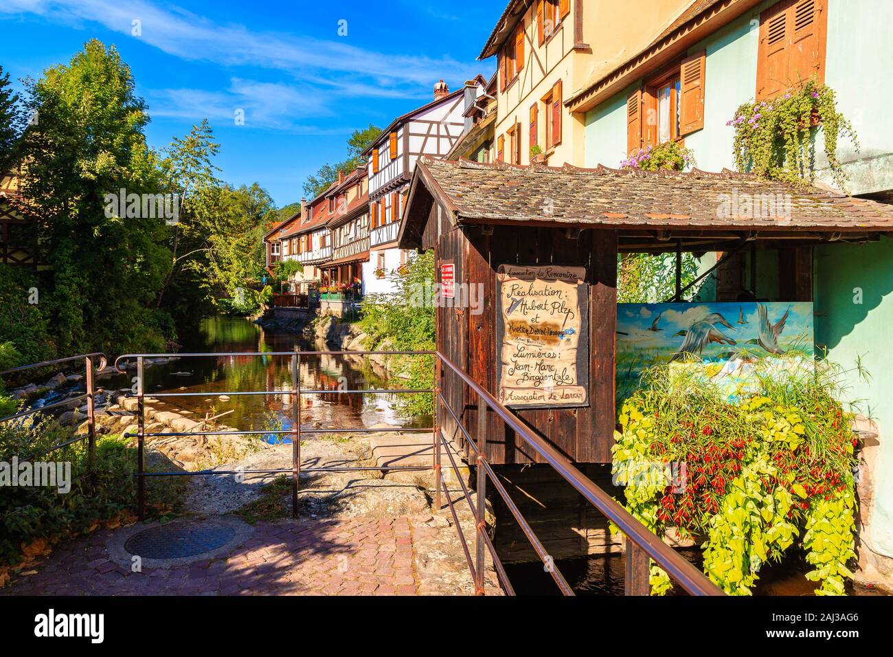 ALSACE WINE REGION, FRANCE - SEP 20, 2019: Beautiful narrow street and colorful houses decorated with flowers in Kaysersberg village which is located Stock Photo