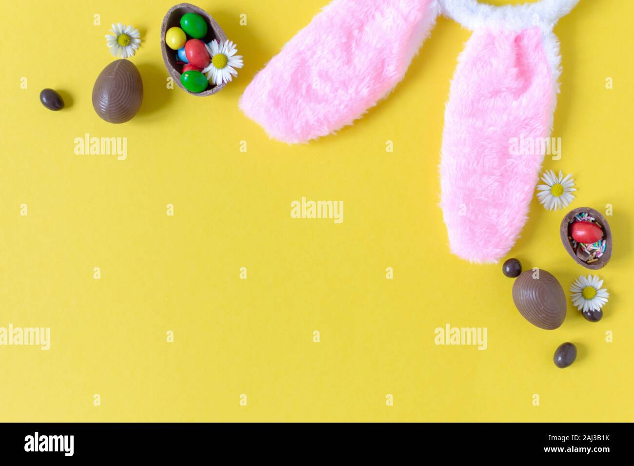 Chocolate Easter eggs on pastel yellow background flat lay. Easter concept. Copy space. Stock Photo