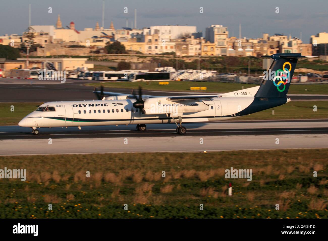 Bombardier Dash 8-Q400 turboprop airliner belonging to Greek airline Olympic Air shown departing from Malta. Air travel in the EU. Short haul flights. Stock Photo