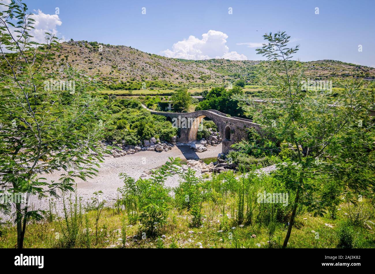 Old ottoman bridge Ura e Mesit near village Boks in Albania Stock Photo