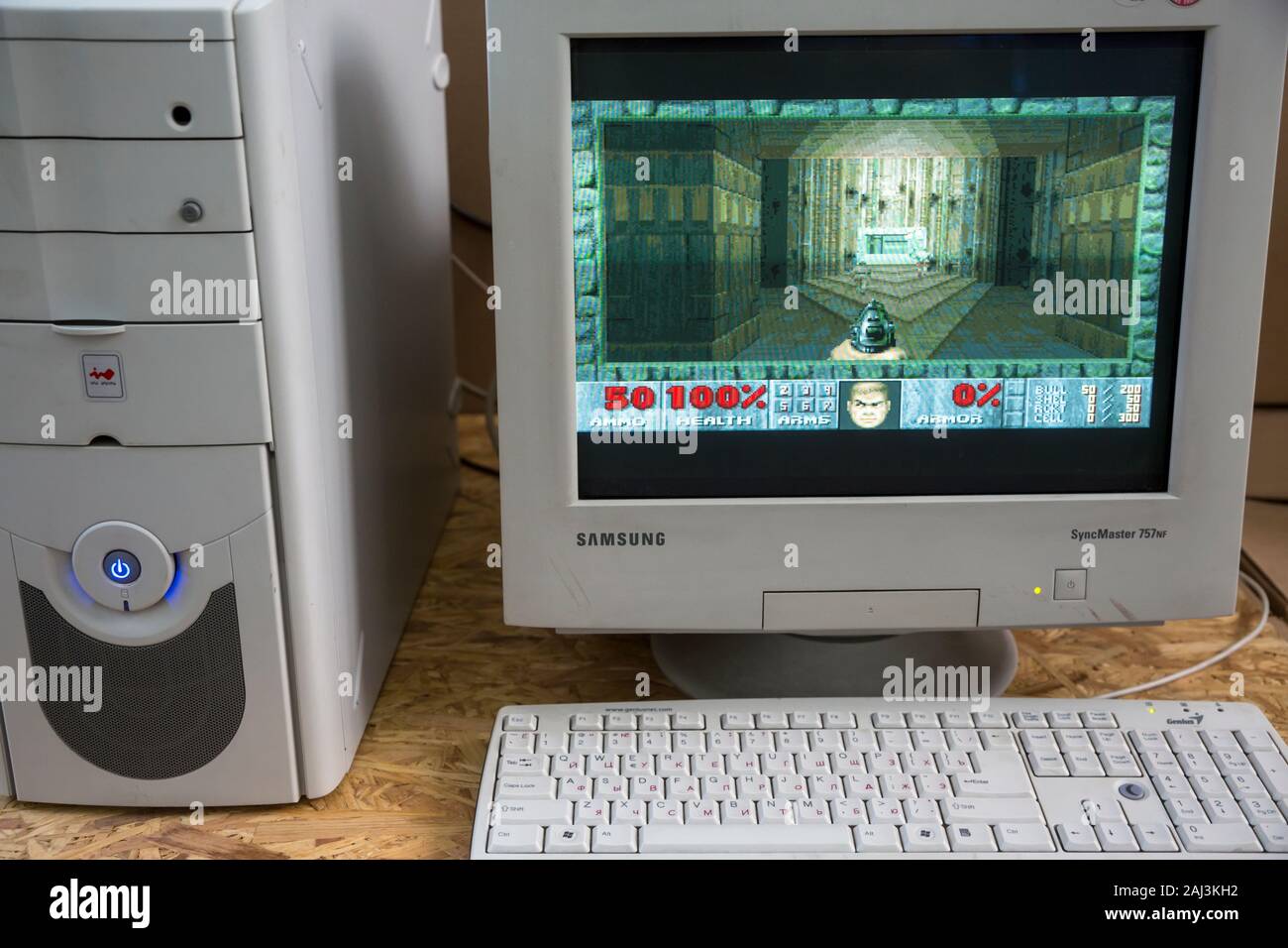 A vintage personal computer from the 1990s with DOOM game loaded on a table Stock Photo