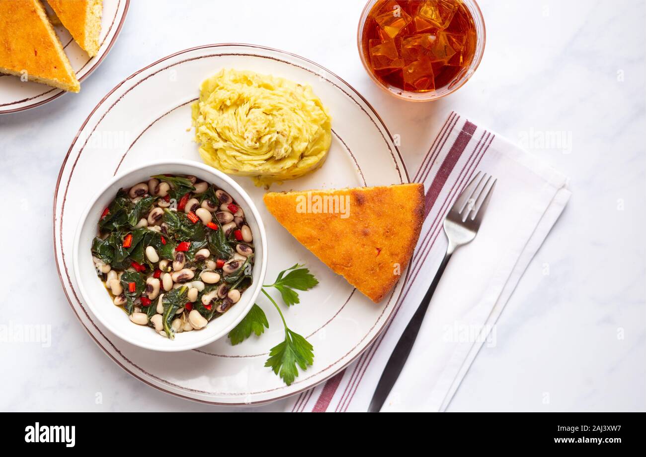 Overhead view of collard greens, blackeye peas, mashed potatoes and