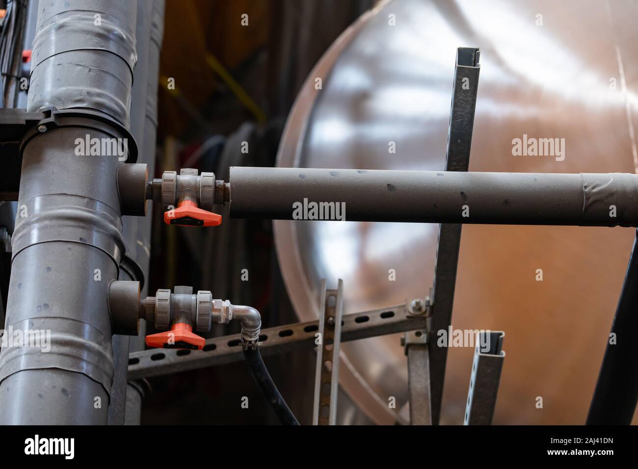 two small tubes, pipes with valves connected to large big Insulation