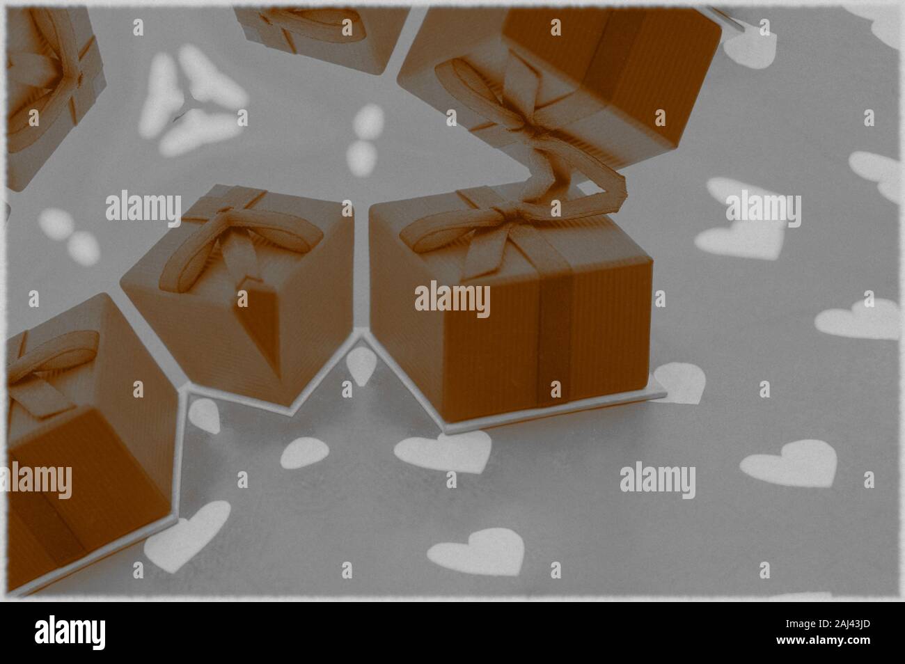 Image with multiple gift boxes with a bow on a background with white hearts, image for Valentine's Day Stock Photo