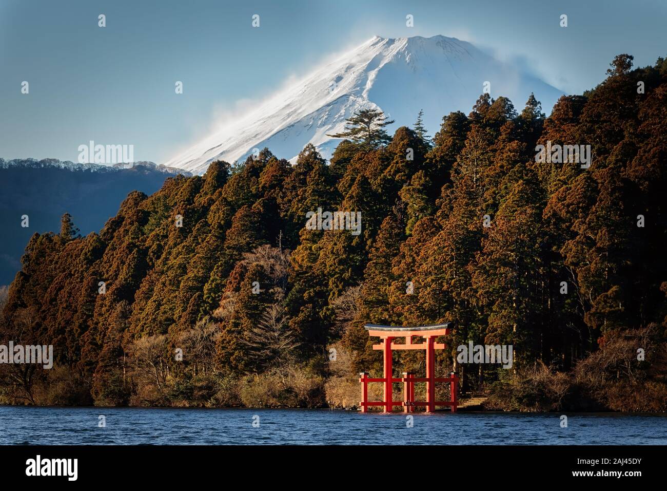 The winds blow snow on Mount Fuji’s peak as seen from Lake Ashinoko in