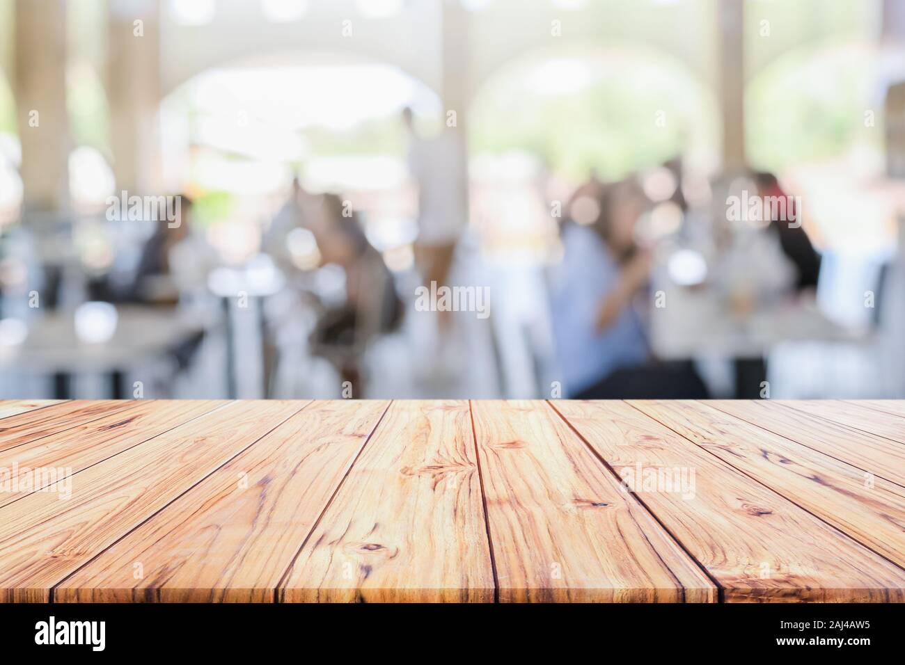 Wooden table top with view on Defocused customer at restaurant blurred background  restaurant background blur cafe coffee shop Stock Photo - Alamy