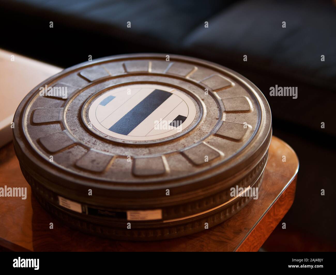 Close-up of old metal movie film reel canister on a wooden table Stock  Photo - Alamy