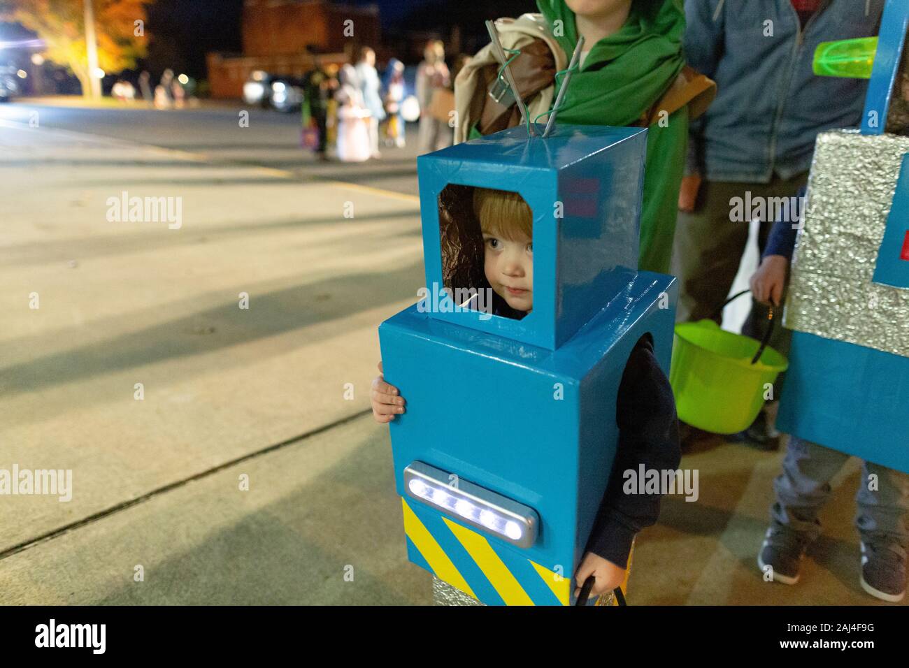 in homemade robot costume stands in line for trick-or-treating Stock - Alamy