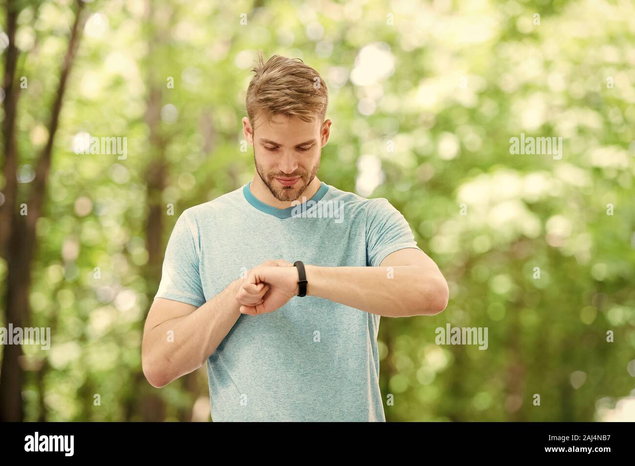 Smart fitness. Fit athlete tracking his fitness activity with sports