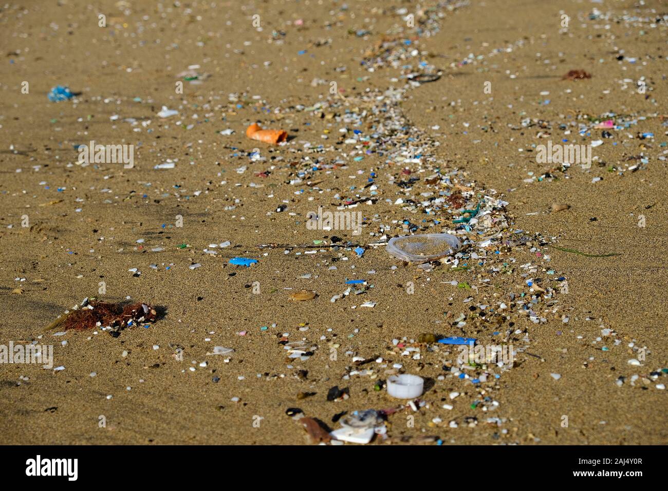 Microplastics debris on a beach. Stock Photo