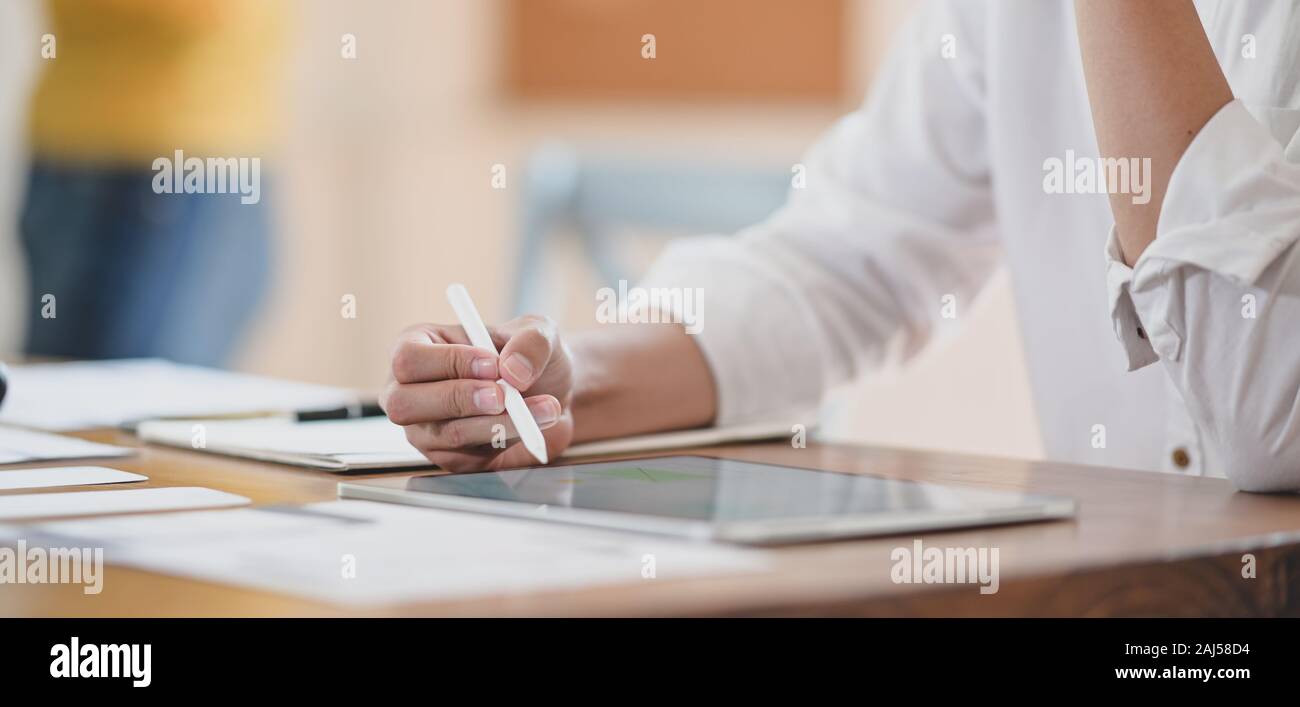 Cropped shot of young professional ux web developer working on her project while using digital tablet Stock Photo