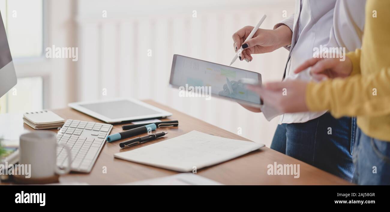 Cropped shot of young professional ux web developer working on her project while using digital tablet Stock Photo