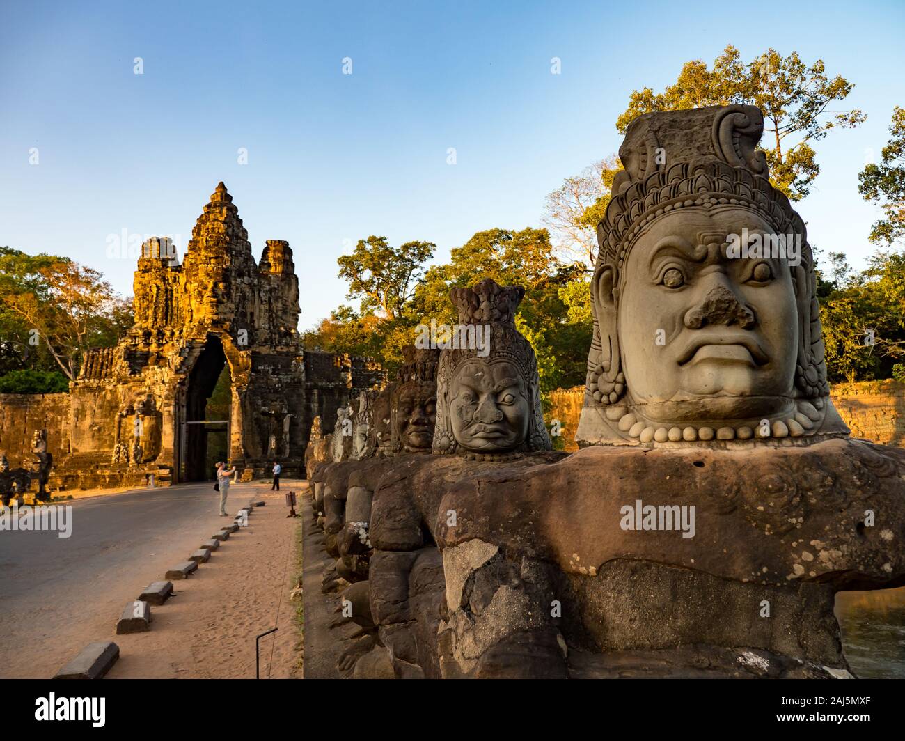 The incredible entrance gate and bridge of Bayon at Angkor Thom near Siem Reap in Cambodia Stock Photo