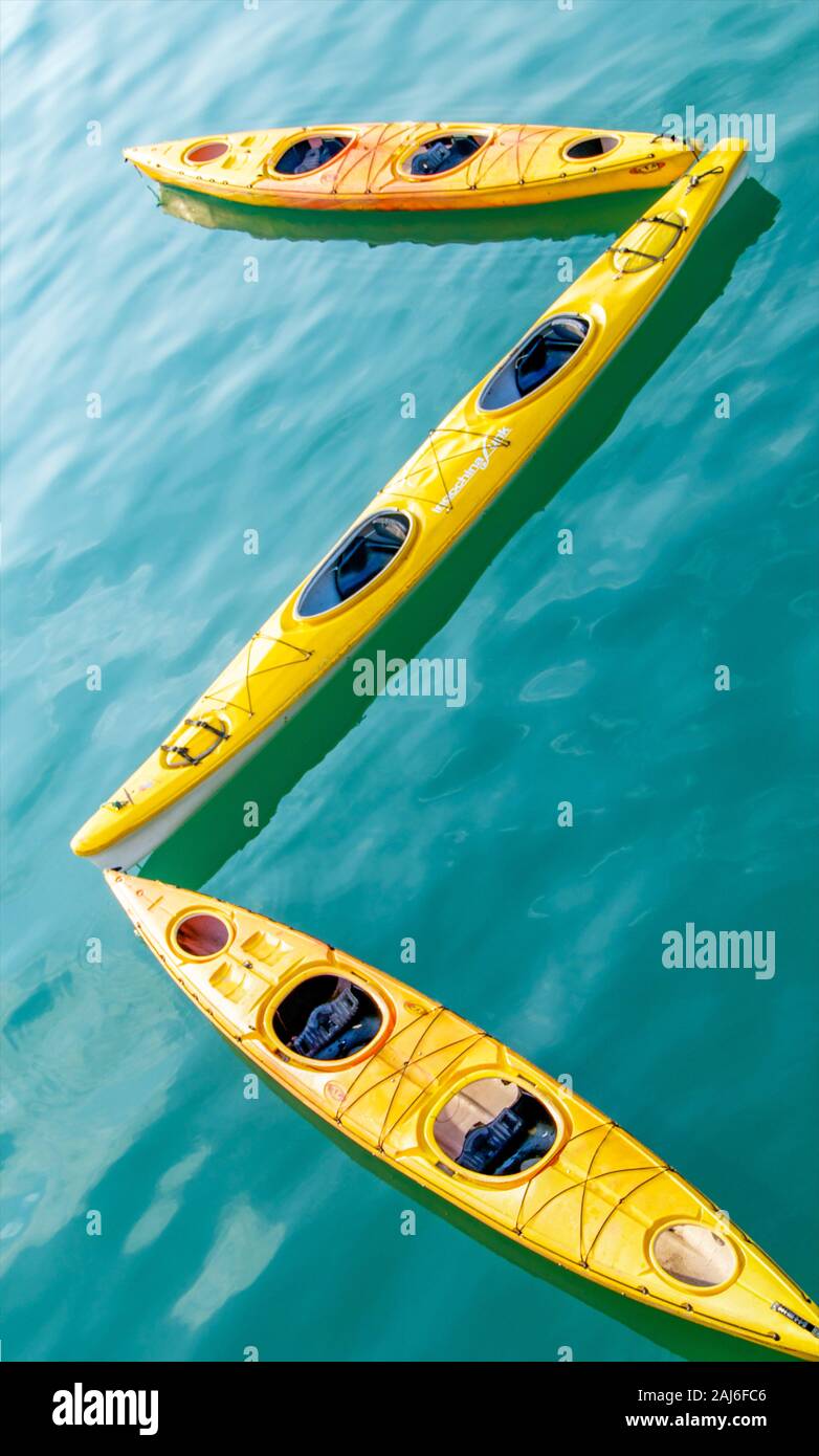 Yellow kayaks and green waters of Ha Long Bay make an interesting contrast in colour and texture Stock Photo