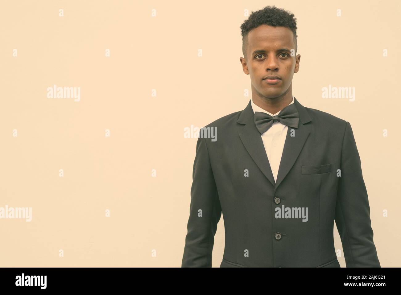 Portrait of young handsome African businessman wearing suit against ...