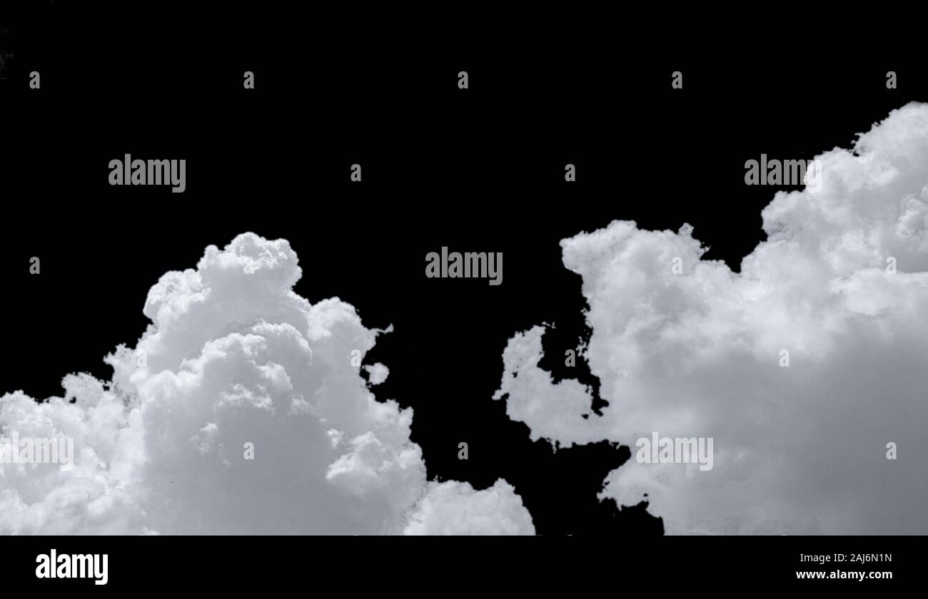 Pure white cumulus clouds on black background. Cloudscape background. White fluffy clouds on dark background. Soft cotton feel of white clouds texture Stock Photo