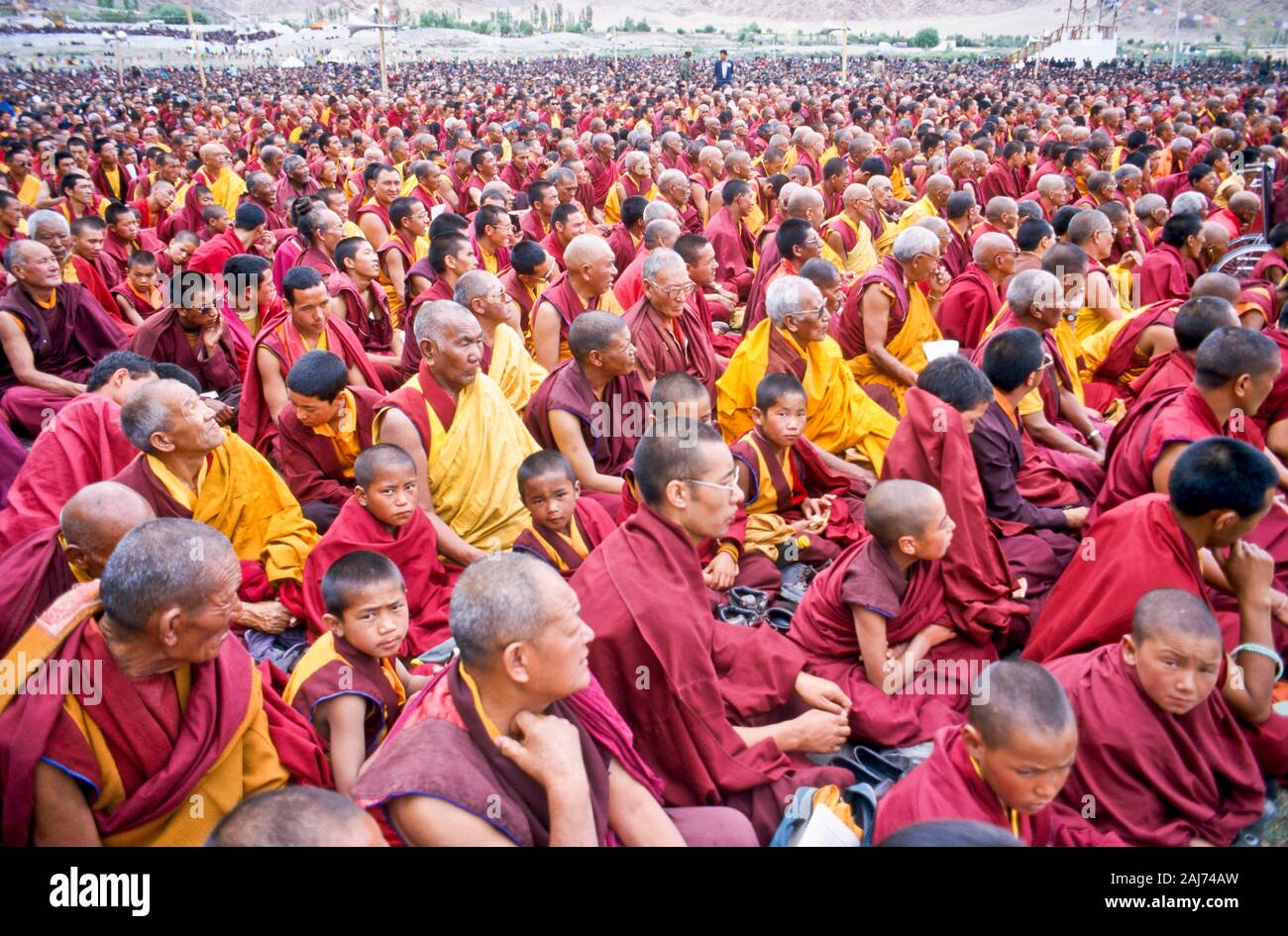 Thousands of buddhist monks listening to the teachings of the Dalai Lama Stock Photo