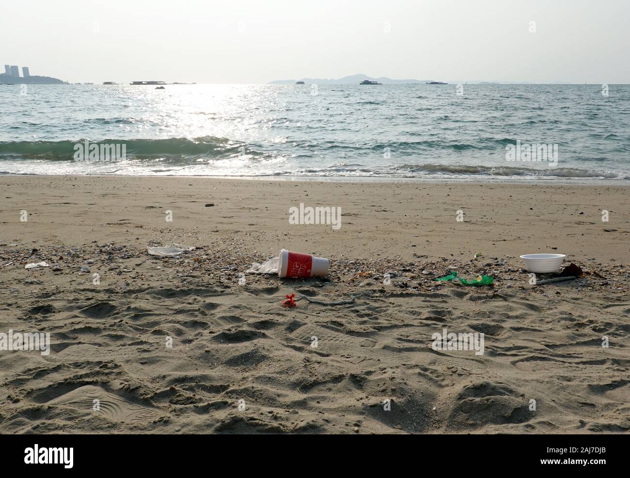 Plastic trash on beautiful beach. Stock Photo