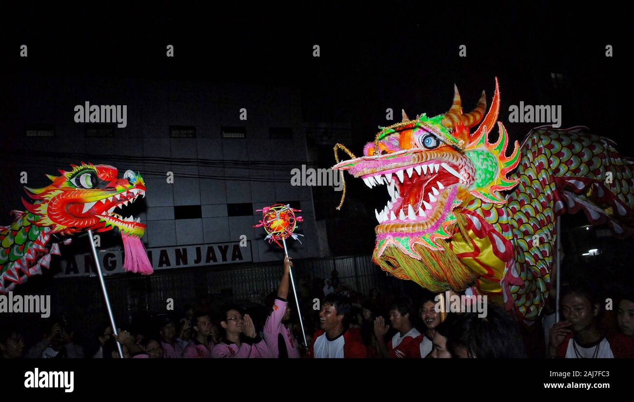 Two dragon puppets play a dragon ball in Chinese new year celebration