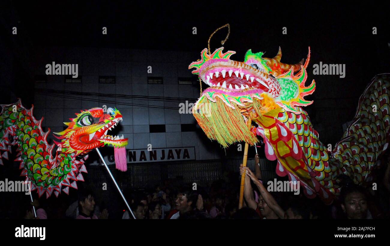 Two colorful dragon puppets meet in Chinese new year celebration
