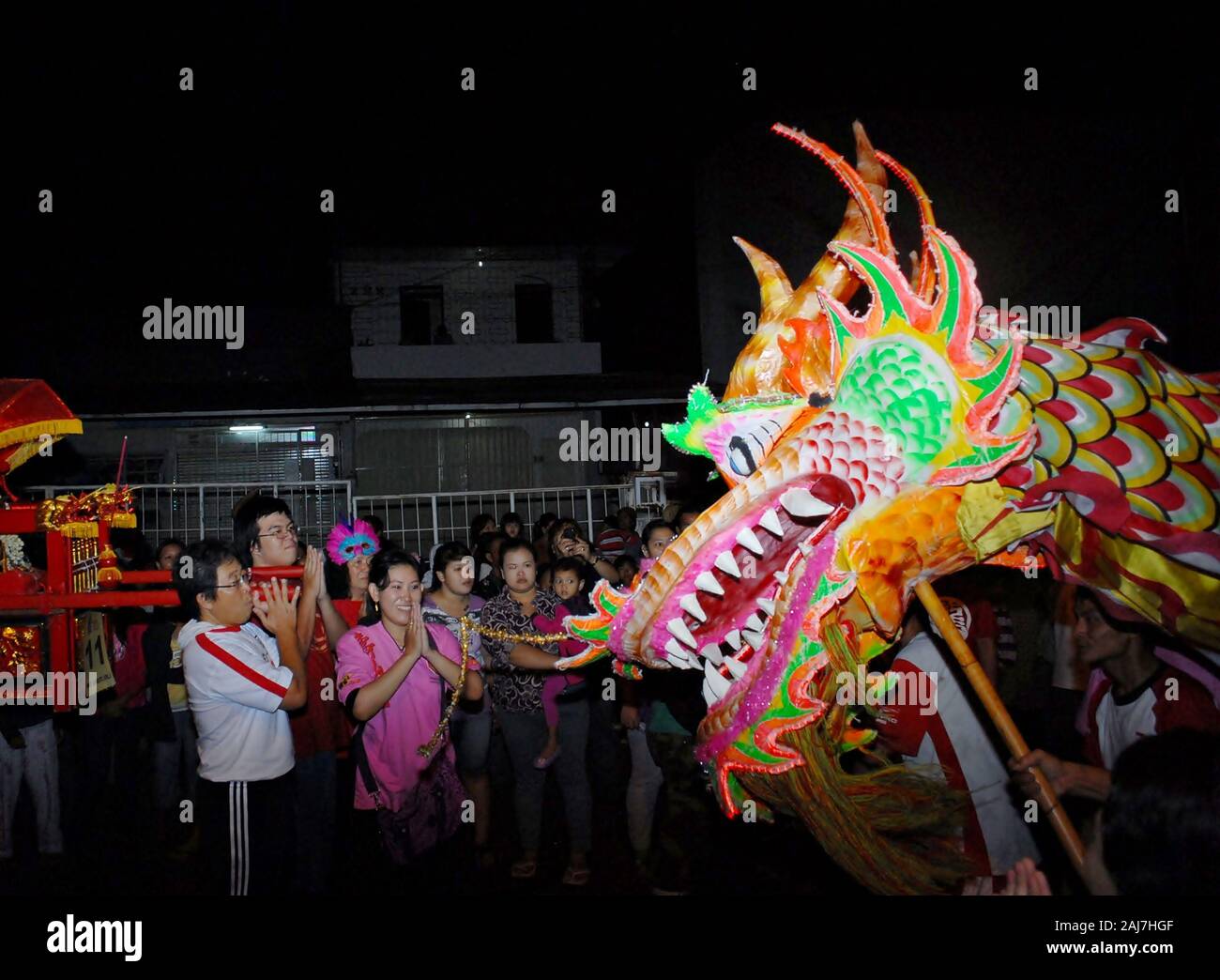 Dragon puppet and the crowd in Chinese new year celebration festival. Stock Photo