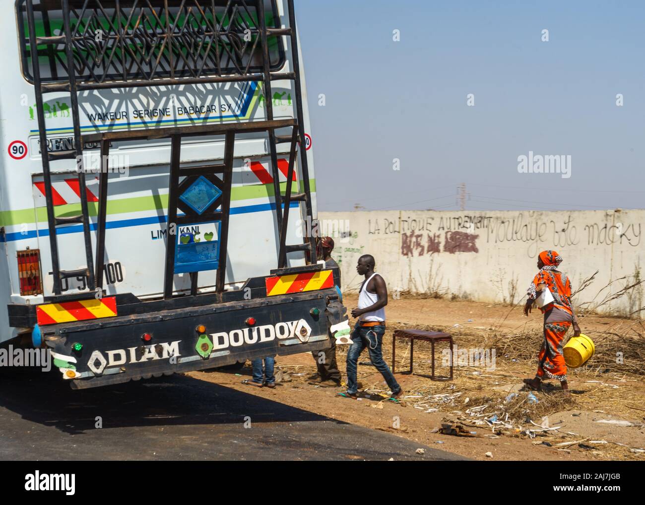 People getting on the bus to Dakar on the roadside in Senegal, Africa - Photograph: Iris de Reus Stock Photo