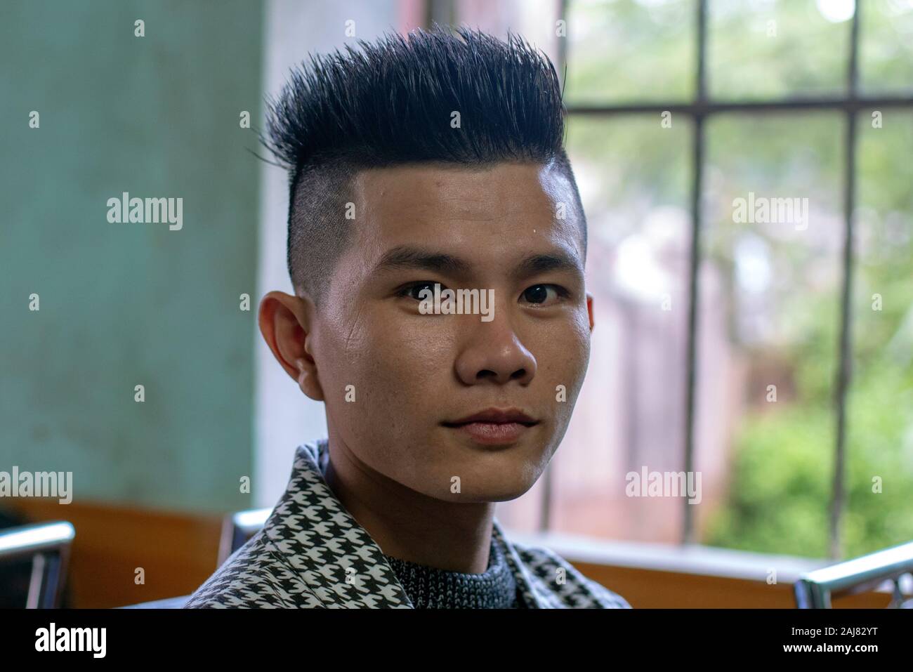 Young asian man cutting hi-res stock photography and images - Alamy
