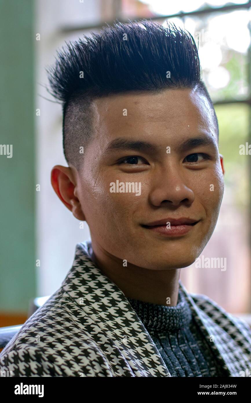 Portrait of a young asian man at modern hair cutting Stock Photo - Alamy